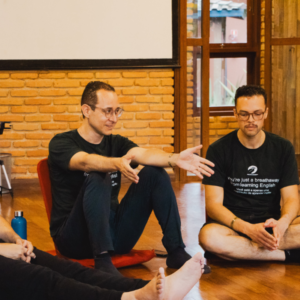 Dois homens conversando sentados durante mentoria de ingles